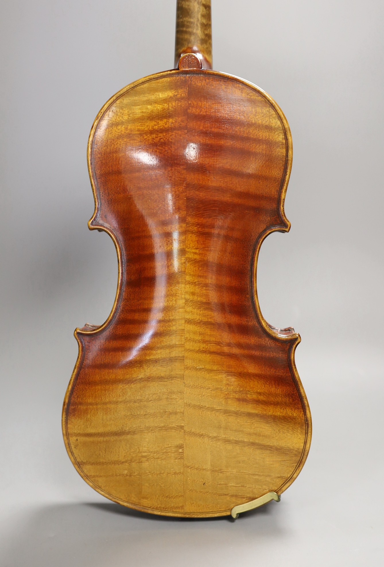 A quarter size late 19th century violin with bow, in E. Hill & Sons case, back measures 29cm